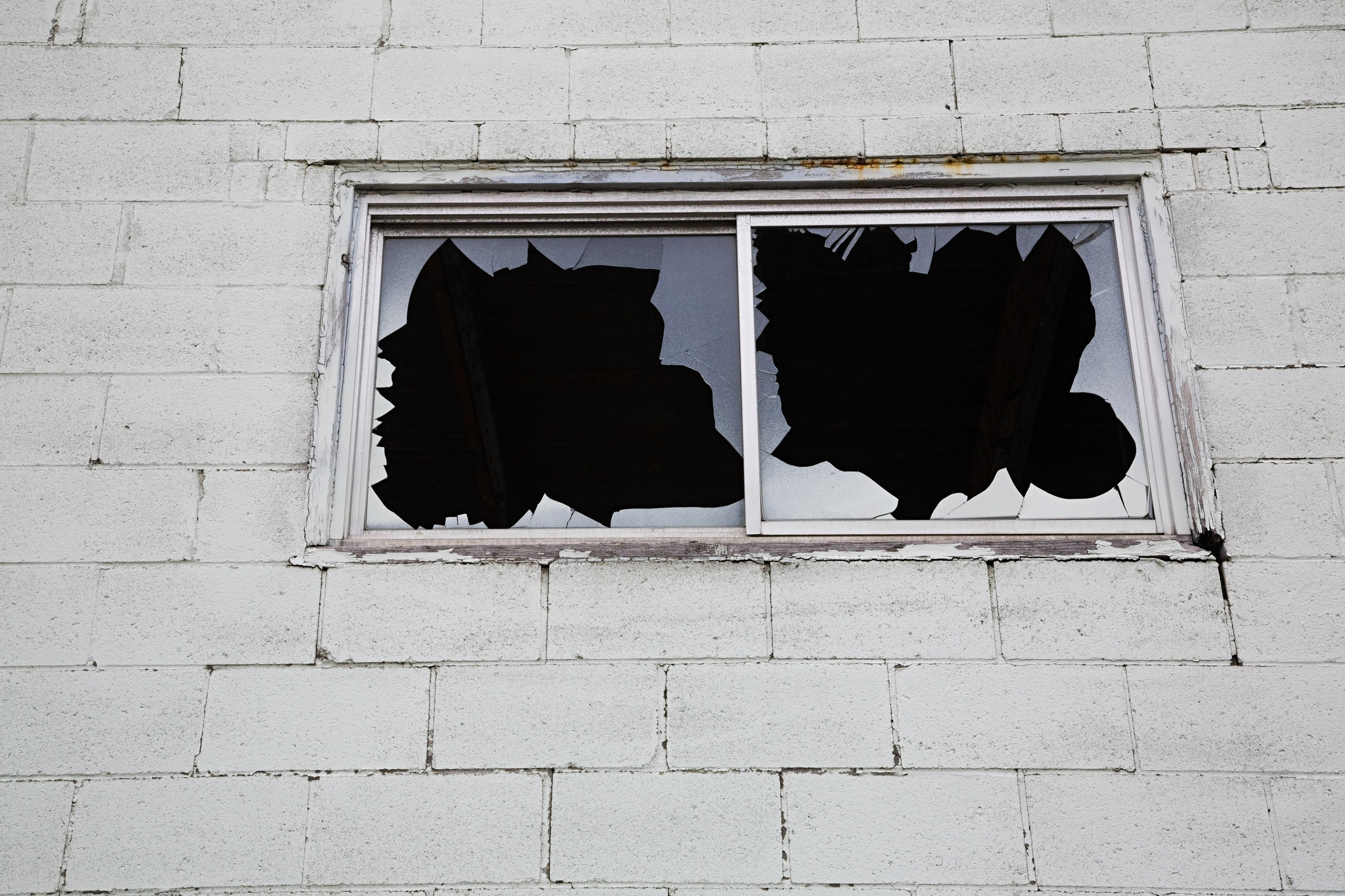Broken window glass after storm damage